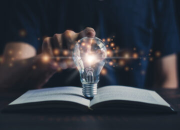Glowing light bulb and book or text book with futuristic icon. Self learning or education knowledge and business studying concept. Idea of learning online class or e-learning at home.